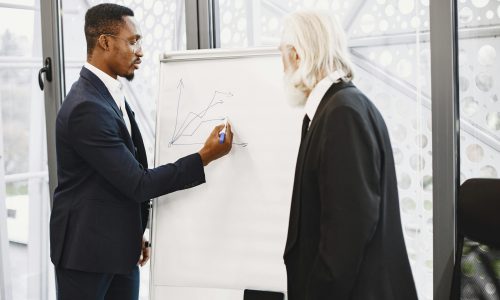 Two business professionals collaborating on a growth strategy in a modern office setting.